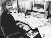 social worker by  computer smiling at camera