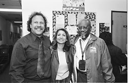 3 social workers standing arm in arm smiling