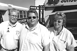 Bus drivers standing with bus in background